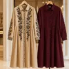 Beige and wine embroidered shirt dresses displayed in a boutique