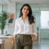 Woman styling a white linen shirt and olive trousers for work