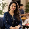 Woman in an embroidered navy suit for a Raksha Bandhan gathering