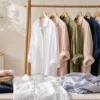 Editorial flat lay of women linen shirts in a boutique studio