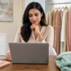 Woman checking women's clothing details while shopping online