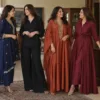 Four women in a suit, co-ord, kaftan and shirt dress at a family function