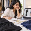 Woman comparing a black co-ord and navy shirt while shopping online