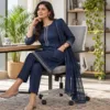 Woman wearing a navy Punjabi office suit at a modern workspace