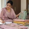 Woman planning a stitching visit with fabric, notes and a travel bag