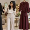 Woman comparing co-ord sets and a shirt dress in a boutique